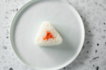 A top down view of a cod roe onigiri.