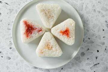 A top down view of a plate of onigiri.