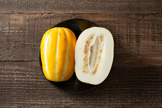 A top down view of a Korean melon on a plate.