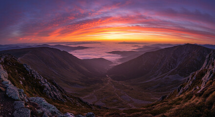 Sunset Viewed from Mountaintop with Misty Valleys Below