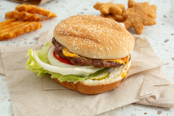 A view of a restaurant style cheeseburger.