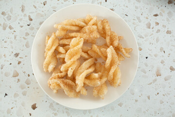 A top down view of a plate of cinnamon twists.