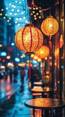 Illuminated lanterns hanging over a wet city street at night.
