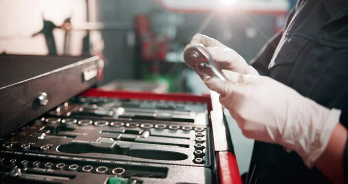 Mechanic, toolbox and hands with tools in garage for car maintenance, repair service and vehicle testing. Motor industry, person and ratchet spanner in workshop for auto inspection and small business