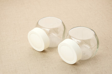 Empty glass spice jar with plastic lid
