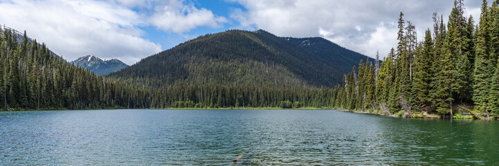 Beautiful waters of the Lightning Lake at Manning Park British Columbia Canada with clouds over the mountains