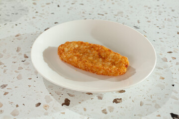 A view of a hash brown on a plate.