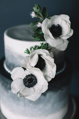 Elegant cake adorned with white flowers captures a sophisticated dessert style for special occasions © tisaeff