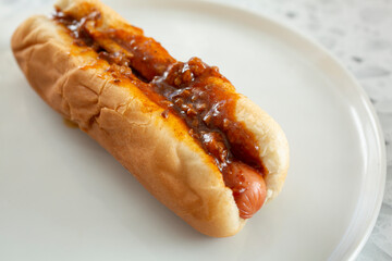 A view of a plate of a chili dog.