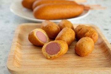 A view of a plate of mini corn dogs.