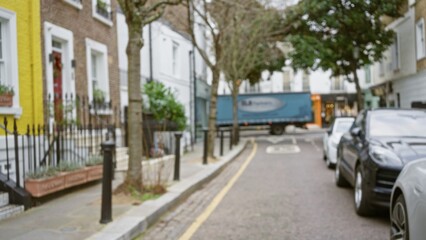 Blurred view of a quiet street in chelsea, london with parked cars and winter trees, creating a serene urban scene in england.