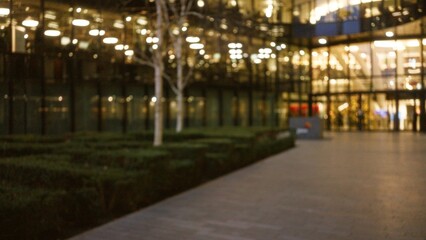 Fototapeta premium Blurred scene of a london street at night with defocused lights, creating a winter atmosphere in the urban cityscape, featuring bokeh and a soft focus foreground.