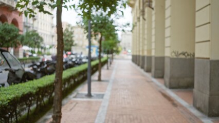 Blurred street scene in la spezia, italy features defocused urban environment with trees and architecture, creating a serene, european town atmosphere with a focus on textures.