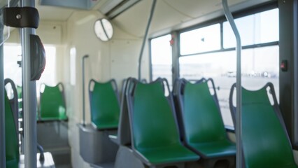 Interior showing an empty bus with green seats in soft focus and natural light highlights the...