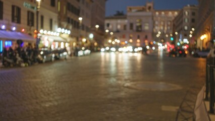 Night scene with defocused lights in an old town street in rome, italy, showcasing blurred bokeh and warm ambiance under a dark sky outdoors.