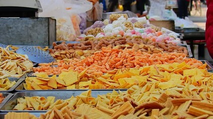 Explore the flavors of traditional Chinese street snacks at a bustling market stall