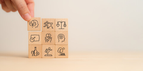 Holistic Wellness Concept. Wooden block with wellness icons, health care ,including mental...