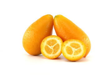 Two kumquats and two halves showing the pulp on a white background