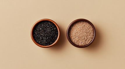 Minimalist composition of two small bowls containing black and white seeds on beige background, showcasing natural textures and colors
