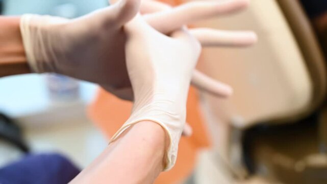 Dentist wearing a gloves in a dental room