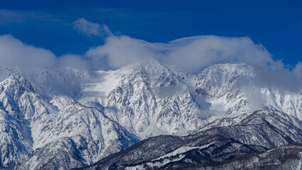 晴天の空と雪の北アルプス　長野県白馬村