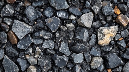 Dark gray and black stones, various sizes and shapes. Ideal for backgrounds, textures, or construction themes.