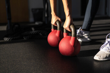 Athletic bodybuilding sport woman squat with kettlebell fitness training at gym.