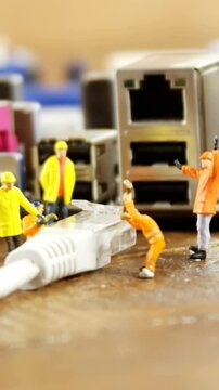 Close-up of figurine with cable and computer socket