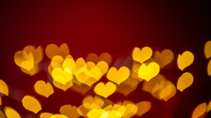 Vibrant heart-shaped bokeh lights create a dreamy, romantic atmosphere on a deep red background,...