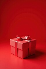 A Crimson Gift Box with a Delicate Satin Ribbon Bow on a Matching Background