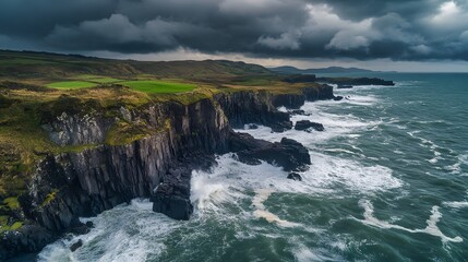 Dramatic coastal cliffs with turbulent waves, rugged landscape under a stormy sky, perfect for nature themes and outdoor adventure.