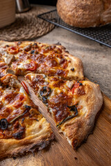 Homemade Sourdough pizza on Wooden Table.