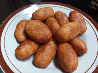 Timus Ubi Kuning or Sweet Potato Balls, Indonesian snack made from mashed sweet potato, sugar and flour. Then fried until beautifully golden.