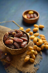 Basket of ripen dates along with bunch of young, yellow date fruits. Middle East and Africa is the biggest producer of date fruits.