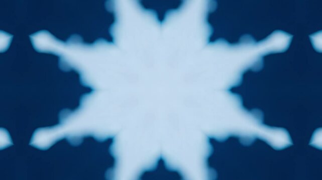 Blue and white patterned design with snowflakes. The design is circular and has eight sides