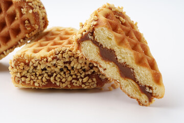 Delicious crispy wafers filled with creamy caramel and coated in crunchy nuts