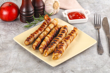 Grilled meat sausages wrapped bacon