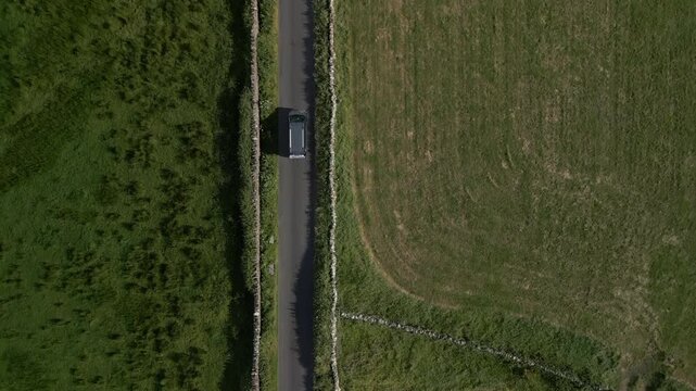 Aerial video of a vehicle traveling in the Doolin Tower area, Ireland