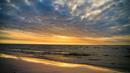 Gorgeous sunset. The sun is on the horizon. Beautiful clouds. Play of colors.