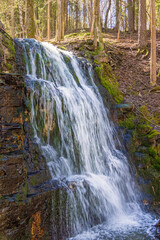 Waterfall on a cliff in a forest