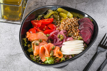 Buckwheat salad with capers, salmon and pickles. Healthy eating concept