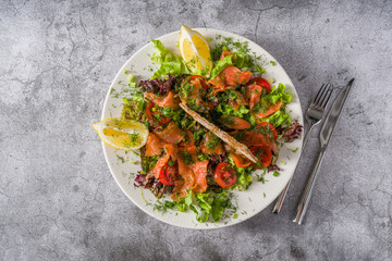Salad with smoked salmon on stone table. Healthy eating concept