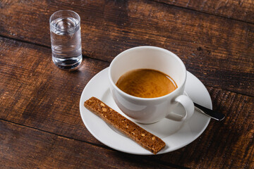 Espresso in white porcelain cup on wooden table. Espresso coffee