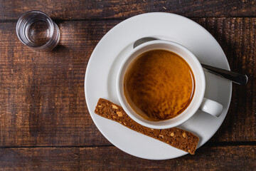 Espresso in white porcelain cup on wooden table. Espresso coffee