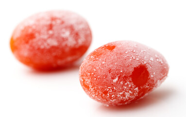 Two small, frozen red tomatoes
