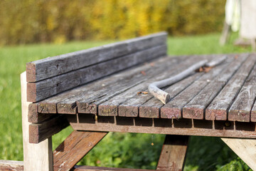 Naklejka premium old wooden table with chairs located in the garden.