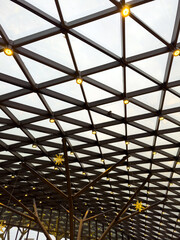 Fototapeta premium A large, open space with a lot of light shining through the glass ceiling