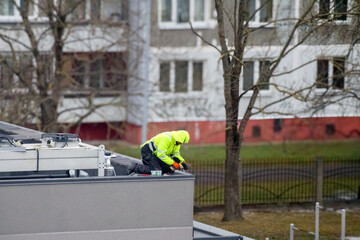 Fototapeta premium a man is seen working on the roof.