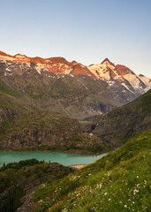 Glacial turquoise Lake Sandersee near Austrias highest mountain Grossglockner with snowy peaks. Carinthia. Austria