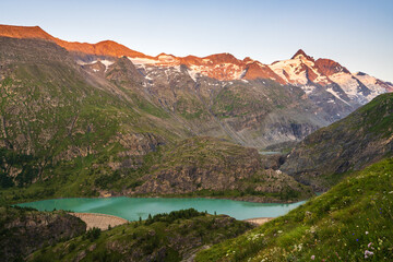 Glacial turquoise Lake Sandersee near Austrias highest mountain Grossglockner with snowy peaks. Carinthia. Austria